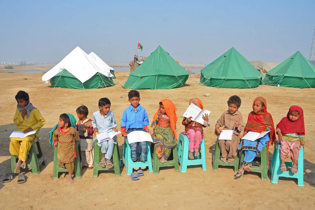 Ces enfants du Pakistan (Asie) ont tout perdu lors des inondations catastrophiques de l’été dernier. Ils vivent sous tente et suivent l’école dehors.